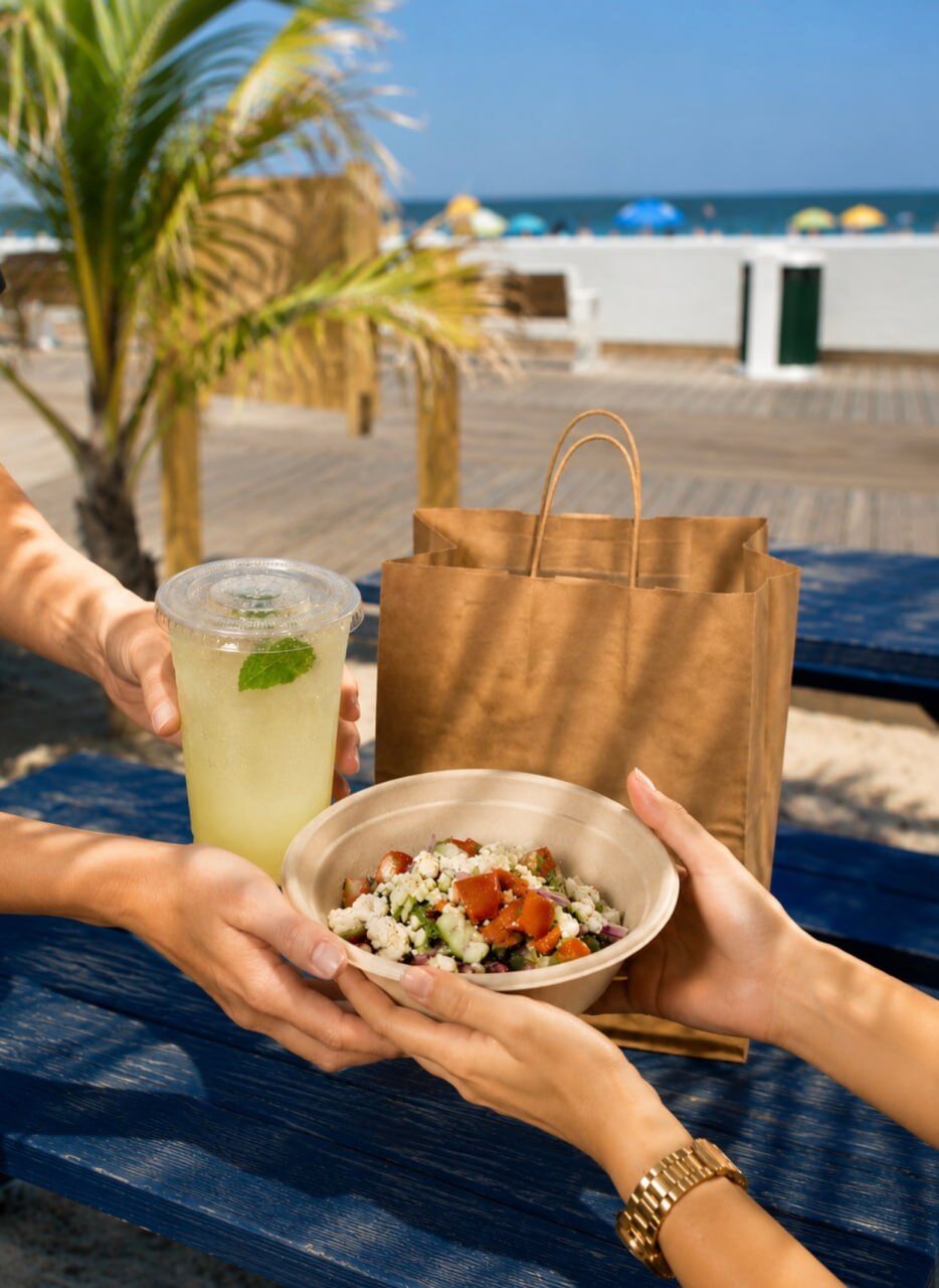 Greek salad bowl and mint lemonade served on the boardwalk